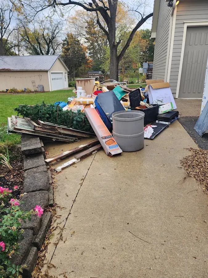 Dumpster being loaded with debris for Estate Cleanout Dumpster Rental in Moapa Valley